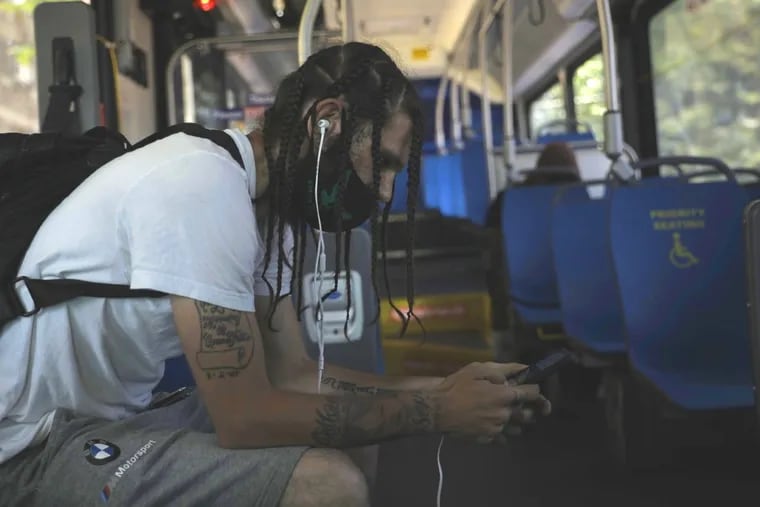 A man sits in a SEPTA cooling bus along Allegheny Avenue and Germantown Avenue a heat wave last year.