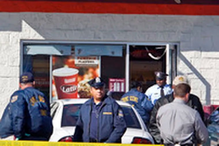 Police at the Dunkin&#0039; Donuts where Officer Cassidy was shot.