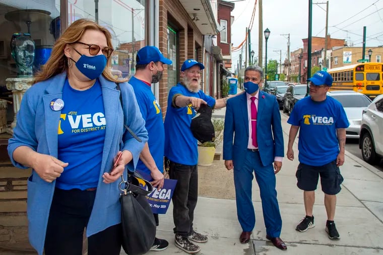 Aleida Garcia, left, whose son Alejandro Rojas-Garcia was killed in 2015, campaigns with Democratic district attorney candidate Carlos Vega, second from right, in the Port Richmond section of Philadelphia on April 29. Crime victims and their friends and family have emerged as some of the most visible figures in the campaign against District Attorney Larry Krasner.