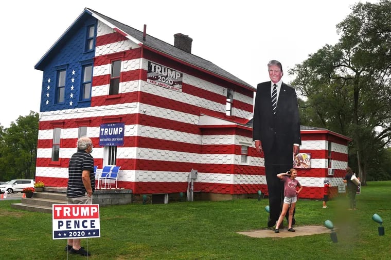 Visitors stop at the “Trump House” in Youngstown, Pa Sept. 2, 2020, the day before President Trump's campaign rally in nearby Latrobe. The “shrine” to then candidate Donald Trump was created during the 2016 presidential campaign.