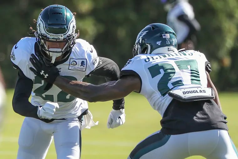 Eagles cornerback Sidney Jones (left) runs a drill with safety Malcolm Jenkins during practice at the NovaCare Complex on Wednesday.