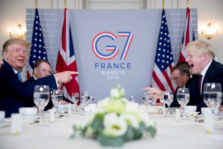 Then-President Donald Trump (left) and British Prime Minister Boris Johnson attending a working breakfast at the G-7 summit in Biarritz, France, in August 2019.