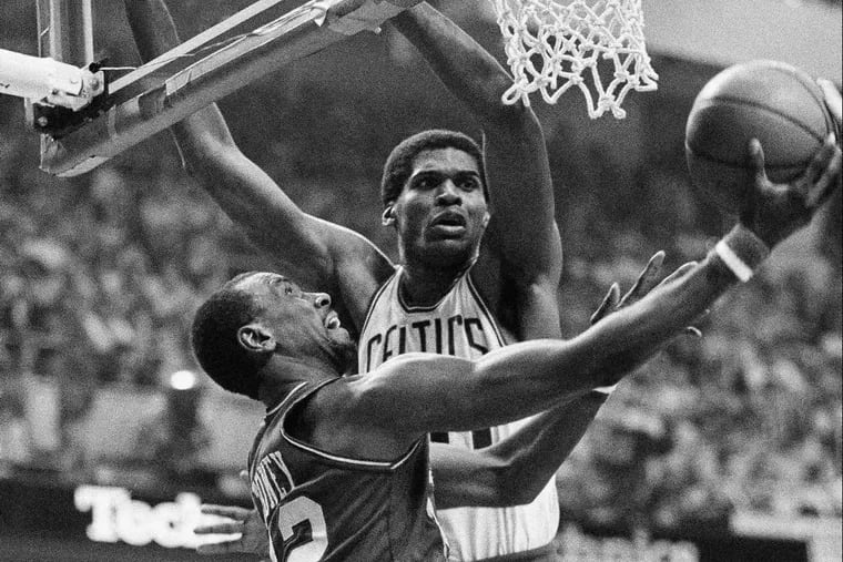 The Sixers' Andrew Toney slips by Boston's Robert Parish for two during Game 7 of the 1982 Eastern Conference finals.