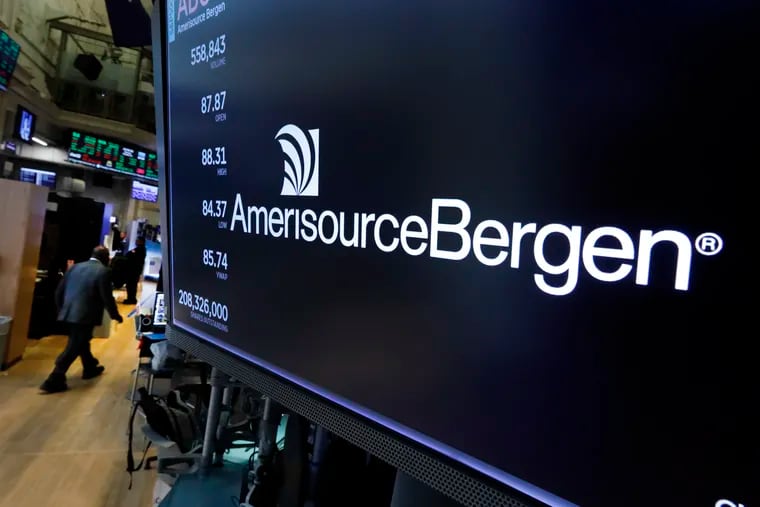 The logo for AmerisourceBergen appears above a trading post on the floor of the New York Stock Exchange on Oct. 21, 2019. McKesson Corp., Cardinal Health Inc. and AmerisourceBergen Corp. will get a chance to test their defenses in West Virginia federal court against charges that they fueled the opioid epidemic. (AP Photo/Richard Drew)