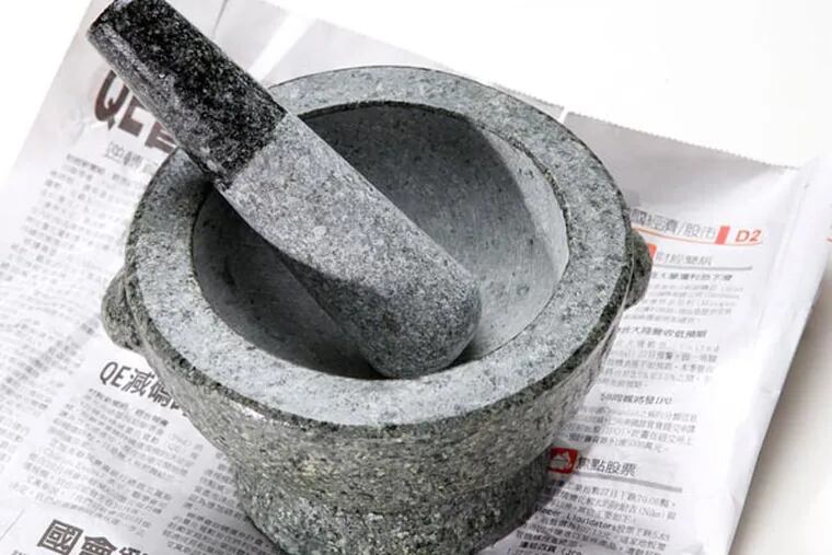 Large stone mortar and pestle ($29.99), at 1st Oriental Market. MICHAEL BRYANT / Staff Photographer