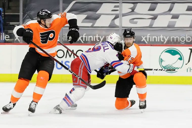 Flyers left wing Michael Raffl and teammate center Connor Bunnaman defend New York Rangers center Colin Blackwell during the second period of Thursday's game.
