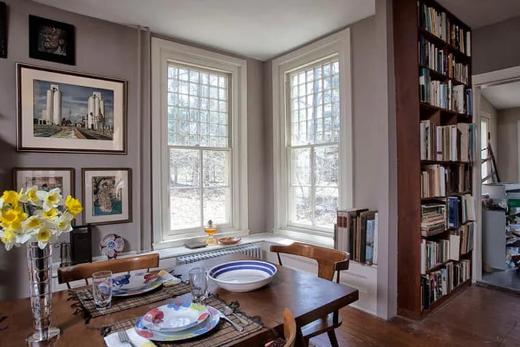 The bright, window-filled dining room. The vintage windows, each featuring 36 small panes over four large ones, fill the house with light.