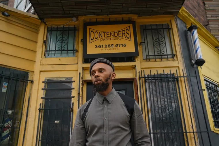 Jamel Workman in front of his Barbershop in West Philadelphia. Workman has been repeatedly pulled over and ticketed in West Philadelphia; many of the violations were dismissed in court.