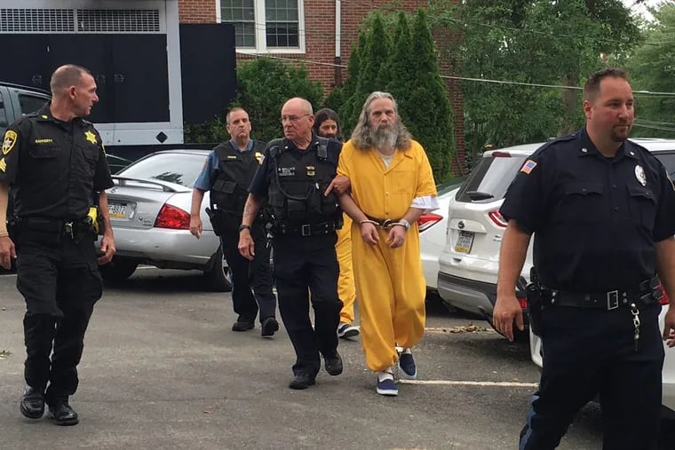 Lee Kaplan, front in yellow, is led to a preliminary hearing Aug. 2, 2016, in Bucks County. (MEGAN TRIMBLE / Associated Press)