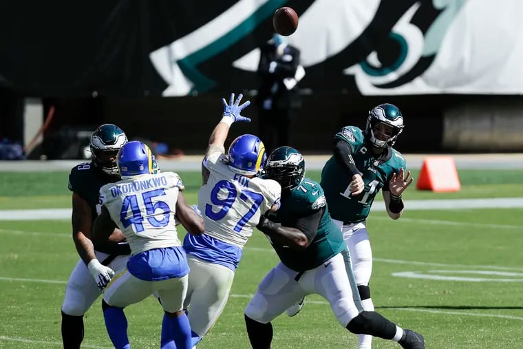 Using a short passing game that allowed him to get the ball out quickly, Carson Wentz wasn't sacked Sunday, which was about the only positive news of his performance.
