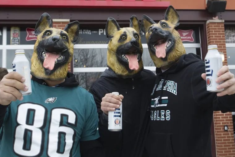 Eagle fans, Adam Gatsis, left, Nick Paris, center, and Mike Stergion, from Toronto, Canada, posed for a photograph wearing dog masks during a tailgate party outside Lincoln Financial Field, Philadelphia. Sunday, January 21, 2018. JOSE F. MORENO/ Staff Photographer