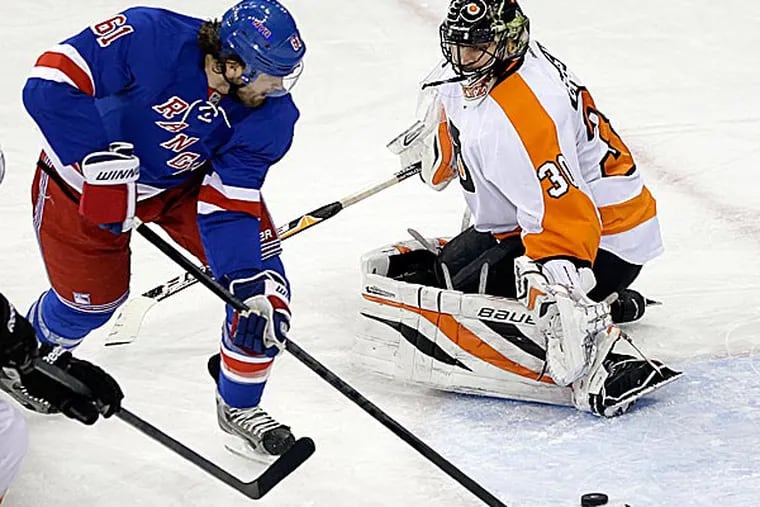 The Rangers' Rick Nash skates past Flyers goalie Ilya Bryzgalov to score a goal during the third period. (Frank Franklin II/AP)