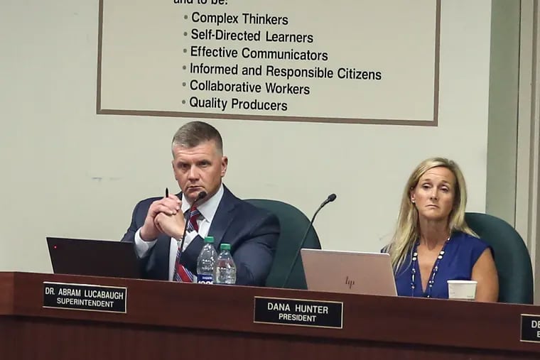 Superintendent Abram Lucabaugh and Board President Dana Hunter listen to members of the public during a July 2022 board meeting.