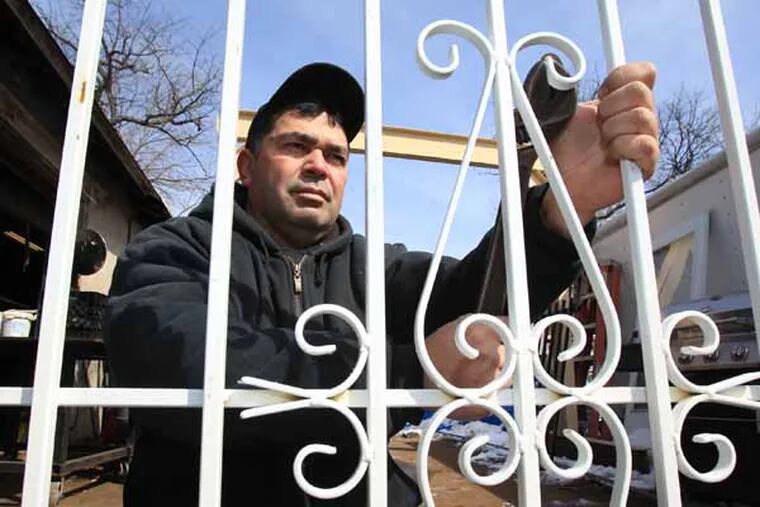Ramon Gonzalez and his family own an ornamental iron works, R & M Ornamental Iron Designs, Inc., in the Cramer Hill section of Camden. He is shown working on an ornamental window covering on March 6, 2014.   ( CHARLES FOX / Staff Photographer )