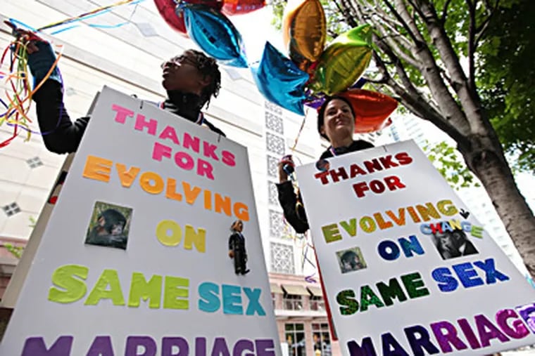 Marriage-equality supporters Teri McClain (left) and Mary Beth Brotski show their approval of the president's remarks at a fund-raising event in Seattle. ELAINE THOMPSON / Associated Press