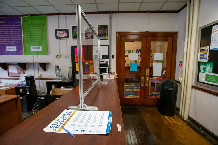 Philadelphia schools are scheduled to reopen March 1. While there's been considerable public pushback against reopening, some parents want their children to return to school. Here, the office at Nebinger Elementary in South Philadelphia is prepped with a plastic shield to protect school staff.