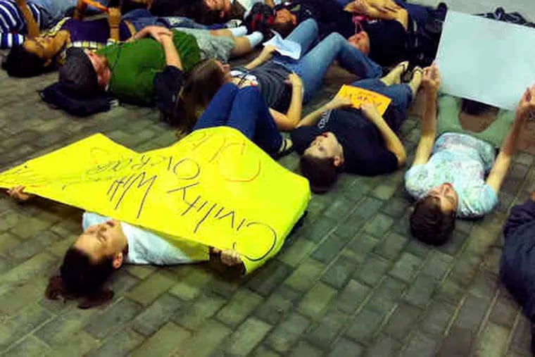 In support of safe places for gay students, a group joins in a &quot;lie-in&quot; near the student center at Rutgers University. The rally was in response to the suicide of Rutgers student Tyler Clementi.