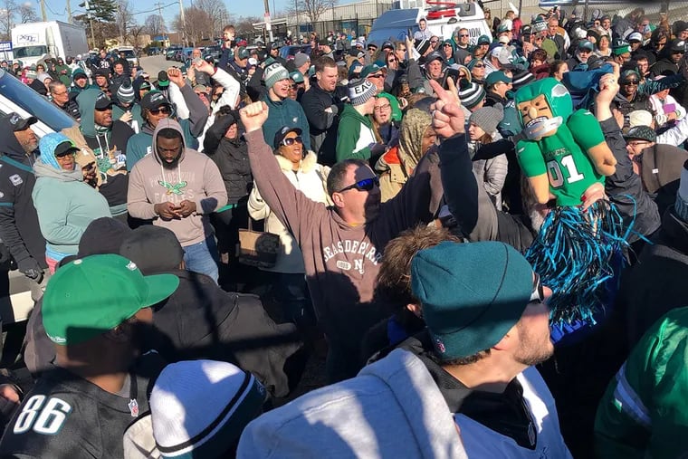 Philadelphia Eagles fans gather outside of Atlantic Aviation on Enterprise Ave near the Philadelphia International Airport for the arrival the winners of Super Bowl LII on Monday afternoon February 5, 2018. JOSE MORENO / Staff Photographer