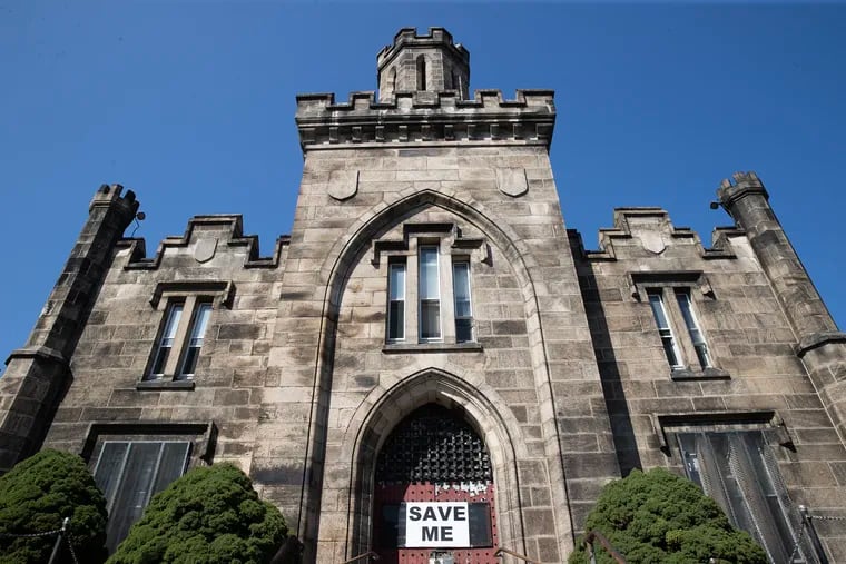Montgomery County is moving forward with a plan to demolish a long-vacant prison in Norristown. It is pictured here in August when preservationists placed a "Save Me" sign on the front door.