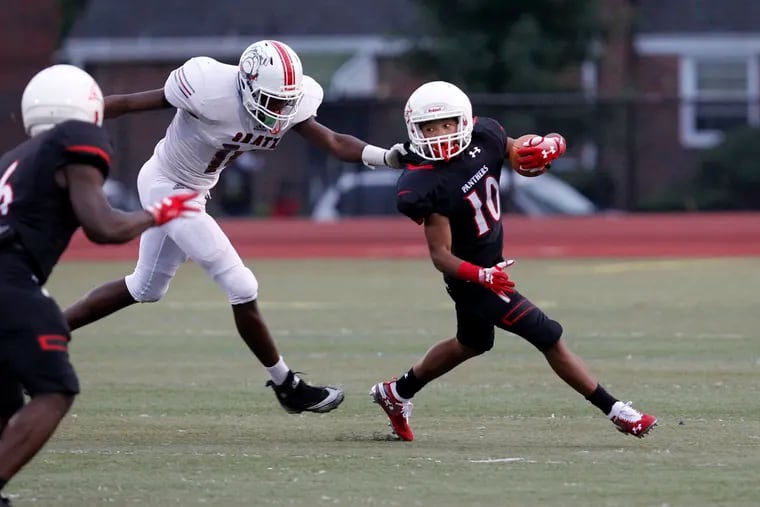 Imhotep's D'Shaun Seals (right) run up field as Gratz's Randy Johnson left defends during the first half of a a high school football on Friday.