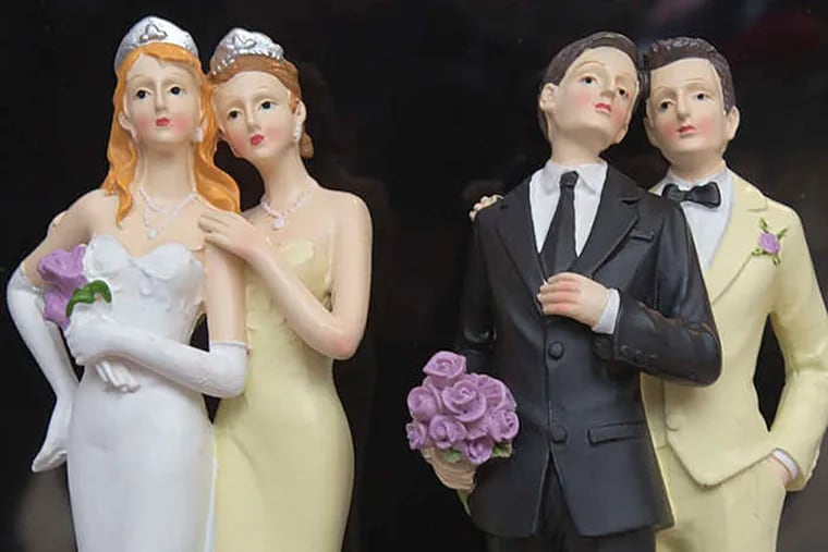 Plastic figurines depict a female couple and a male couple