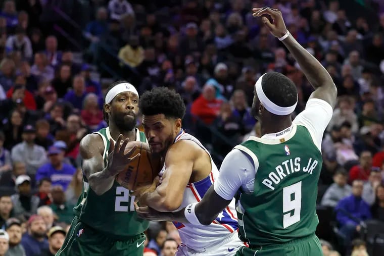 Sixers forward Tobias Harris is sandwiched between Milwaukee's Patrick Beverley and Bobby Portis in the second quarter.