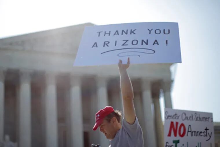 A supporter of Arizona’s "show me your papers" immigration law demonstrates in front of the U.S. Supreme Court. (Charles Dharapak / AP Photo)