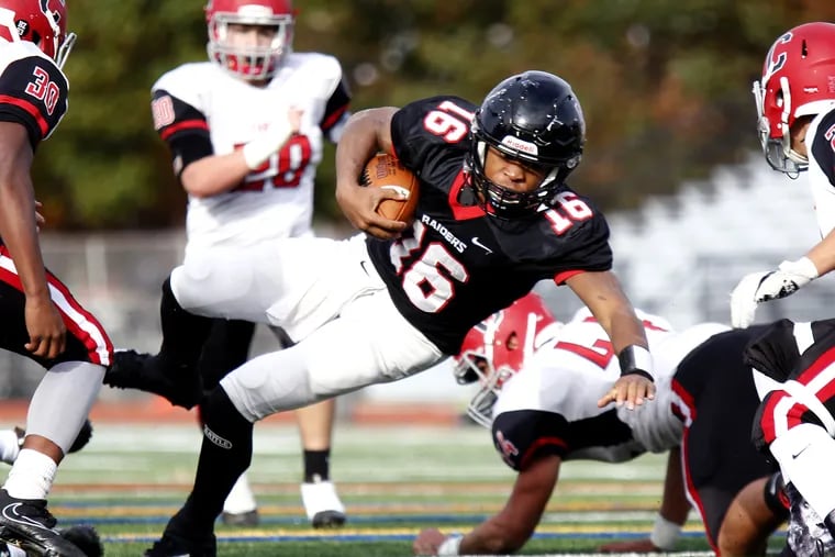 Archbishop Ryan quarterback Jahlil Sanders lunges forward for a gain against Archbishop Carroll during a Philadelphia Catholic League Class 5A football quarterfinal  in 2017. Both of those schools will move forward with football this fall after a delay created by the coronavirus outbreak.