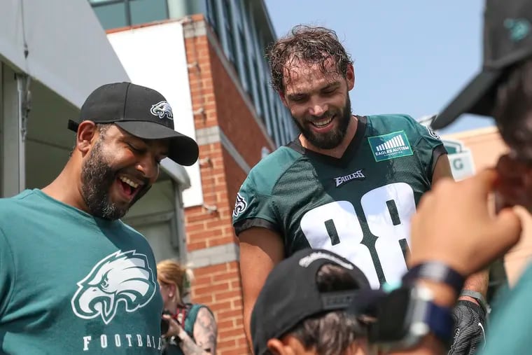 Eagles tight end Dallas Goedert next to Eagles defensive coordinator Sean Desai on the first day of training camp at the NovaCare Complex in Philadelphia on Wednesday, July 26, 2023.