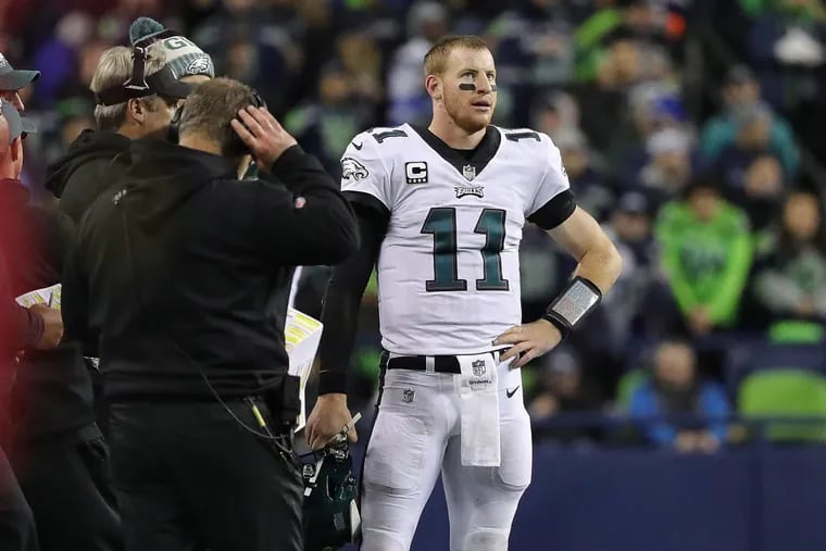 Eagles’ Carson Wentz, right, pauses near the sideline after calling a timeout late in the 2nd quarter. Philadelphia Eagles play the Seattle Seahawks in Seattle, WA on December 3, 2017.