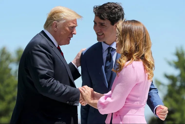 President Trump (left) is greeted by Canadian Prime Minister Justin Trudeau and his wife Sophie Gregoire Trudeau outside the Hotel Fairmont Le Manoir in Quebec, Canada for the G-7 Summit.