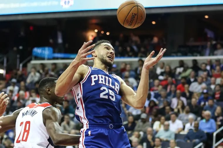 Sixers’ point guard Ben Simmons tries for the rebound over Wizards’ forward Ian Mahinmi during the third quarter at the Capital One Arena in Washington, DC on Wednesday.