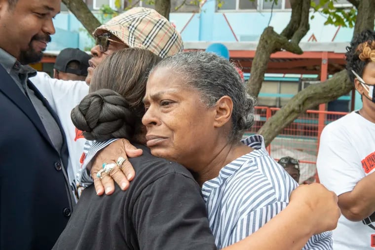 "I've got more dead friends than alive friends," said Louise "Cherokee" Branch, shown here embracing State Rep. Donna Bullock at a Saturday anti-violence rally in North Philadelphia. Branch's first experience with gun violence came as a teenager when a friend was killed in 1973.