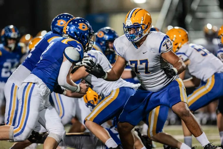 Downingtown East offensive lineman Adham Abouraya (77) squares off with Downingtown West Mason Hale (2) in a quarterfinal game of the PIAA District 1 6A playoffs at Kottmeyer Stadium in Downingtown, on Nov. 11, 2022. Downingtown East beat Downingtown West, 34-9, to advance in the playoffs.