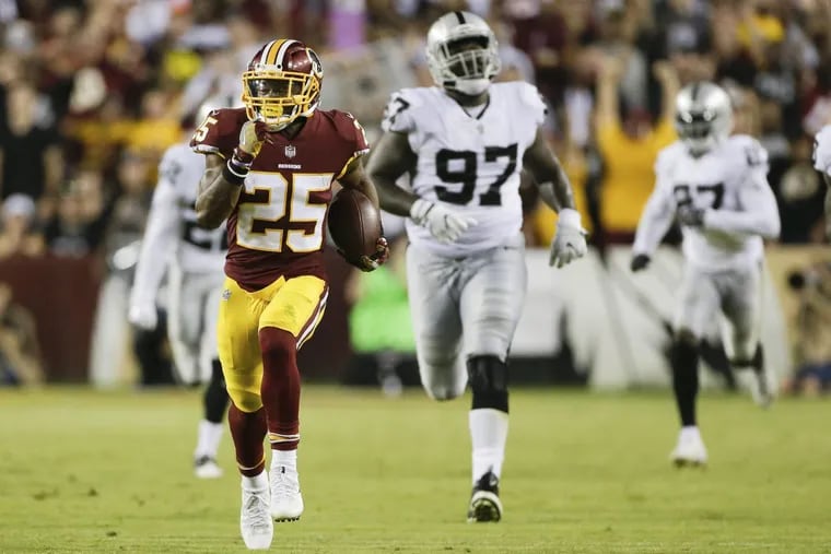 Redskins running back Chris Thompson (left) runs the ball during the second half of the Redskins game against the Raiders on Sept. 24.