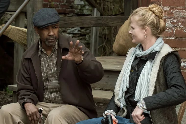 Denzel Washington, director and star, discusses a scene with director of photography Charlotte Bruus Christensen on the set of &quot;Fences.&quot;