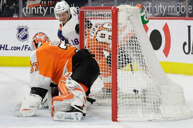 The Islanders' Anthony Beauvillier slides in the overtime winner on a wraparound past Flyers goaltender Brian Elliott.