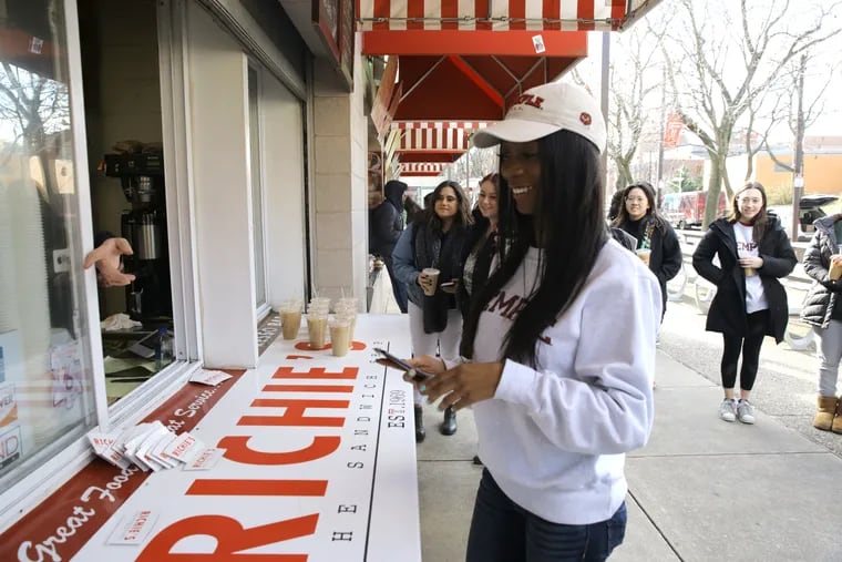 Naomi Abrahams, 20, a media studies and production major at Temple University, uses her new student ID technology to purchase a bottle of water at Richies' on Temple's campus on Friday.