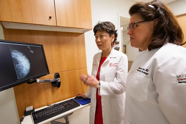 Lydia Liao, Director of the Cooper Breast Imaging Centers, and Generosa Grana, Medical Director of the Anderson Cancer Center at Cooper, examine a scan of Dr. Generosa's breast at Cooper University Hospital in Camden.