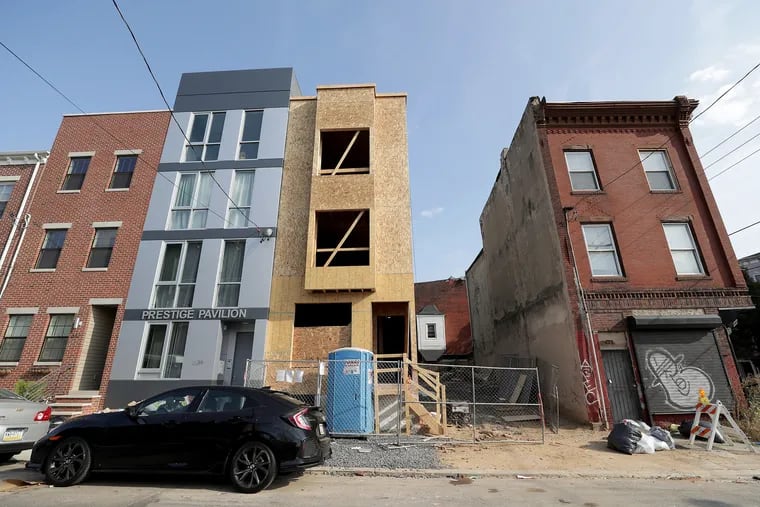 Partners Bryheim Murray and Kyle Easley bought the property where a rowhome is now rising at 627 W. Oxford St, in North Philadelphia. They bought it for $37,500 from an estate and resold it for $155,000 just 19 days later. One of the heirs said it was sold despite her opposition.