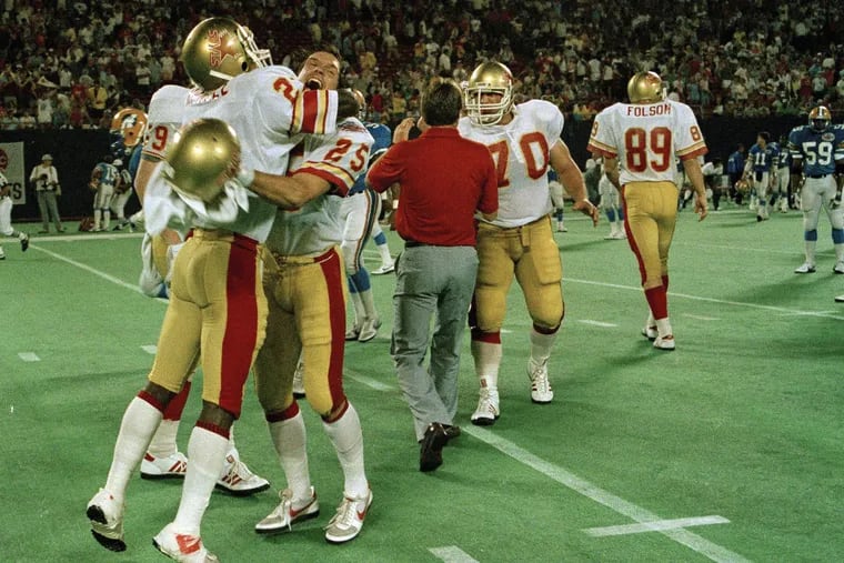 In this July 15, 1985 file photo, Baltimore Stars' Scott Woerner (25) hugs teammate Bill Hardee after winning the USFL Championship football game in East Rutherford, N.J. The team played in Philadelphia before moving to Baltimore. The Philadelphia Stars are now returning as part of the revamped United States Football League, and they unveiled a mascot Monday.