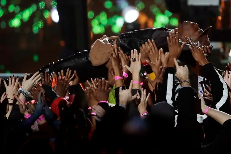 Travis Scott is carried by the crowd during Sunday's Super Bowl halftime show.