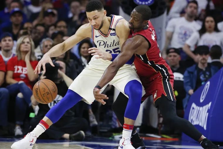Sixers guard Ben Simmons backs down Heat guard Dwyane Wade during Game 5 of the Sixers-Heat playoff series on Tuesday.