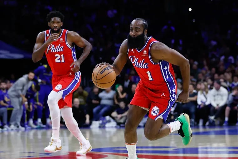 Sixers guard James Harden dribbles the basketball with teammate center Joel Embiid trailing during a game at the Wells Fargo Center.