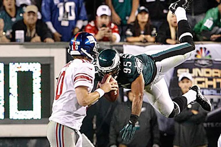Eagles linebacker Mychal Kendricks goes airborne in his pursuit of Giants quarterback Eli Manning. (Ron Cortes/Staff Photographer)