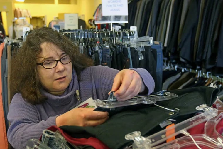 Robin Michaelson sorts through donations at the Jewish Family &amp; Children's Services store in Northeast Philly.