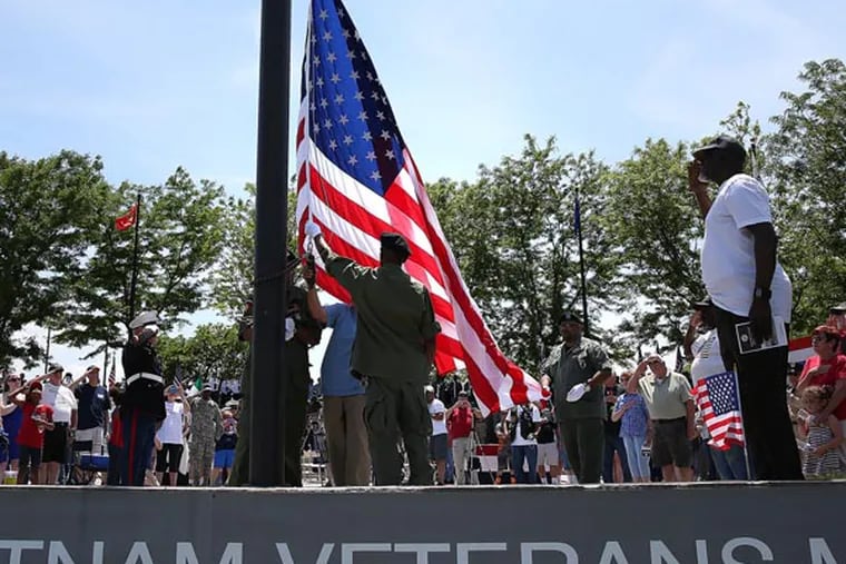 A new flag is raised over the Philadelphia Vietnam Veterans Memorial during the annual Memorial Day service in Philadelphia on May 26, 2014. ( DAVID MAIALETTI / Staff Photographer )