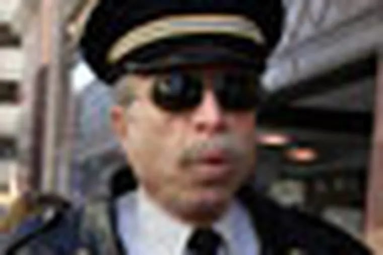 Former Philadelphia Police Captain Ray Lewis, wearing his old uniform,  joins members of Occupy Philadelphia as they walk along Market Street near 7th Street in Philadelphia, Pa. on February 13, 2012. ( David Maialetti  / Staff Photographer )