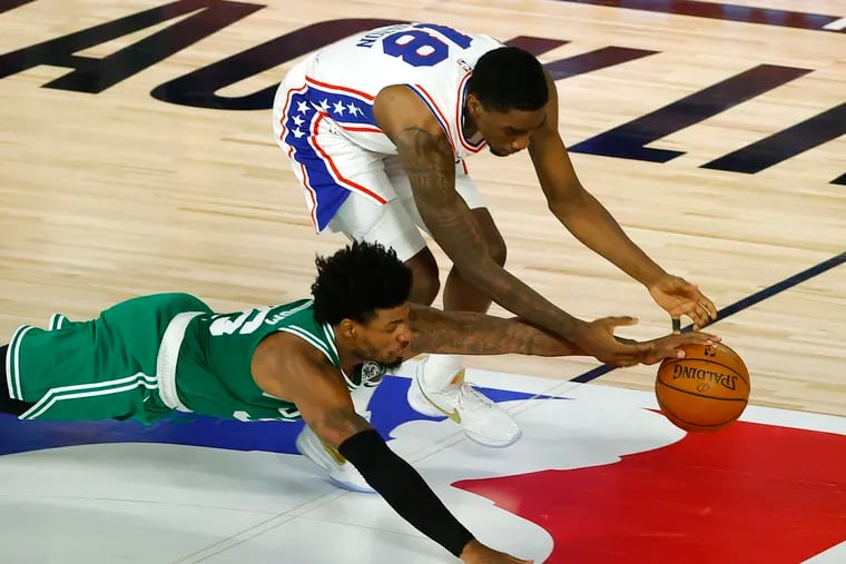 Marcus Smart, left, of the Boston Celtics knocked the ball loose from Shake Milton of the Sixers during the first half of Game 2 Wednesday.