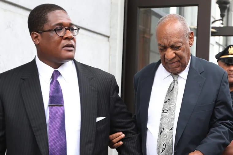 Bill Cosby leaves Montgomery County Courthouse with his spokesman, Andrew Wyatt, after a mistrial was declared Saturday.